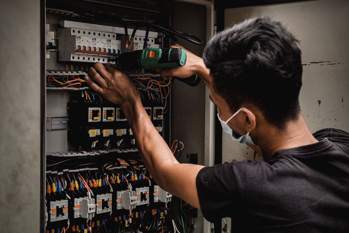 Electrician working on an electrical distribution panel