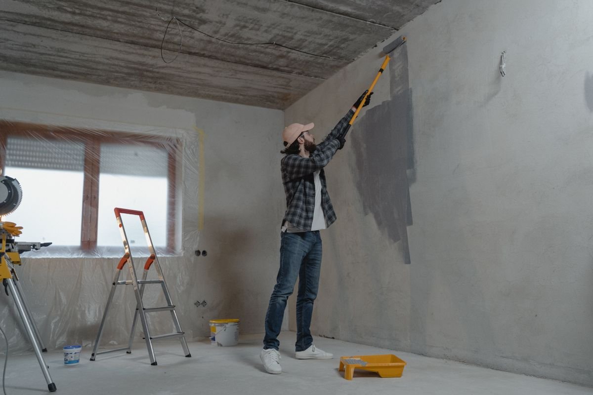 Painter applying a fresh coat to an interior wall